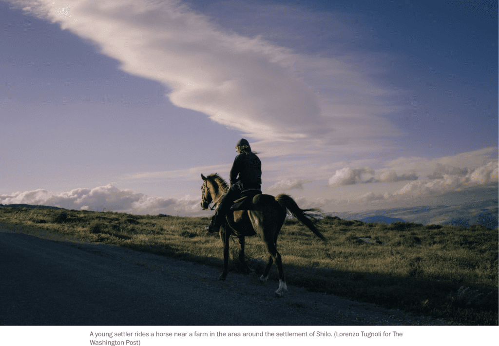 Washington Post - An Israeli settler who illegally occupies Palestinian land rides a horse and surveys Palestinian lands